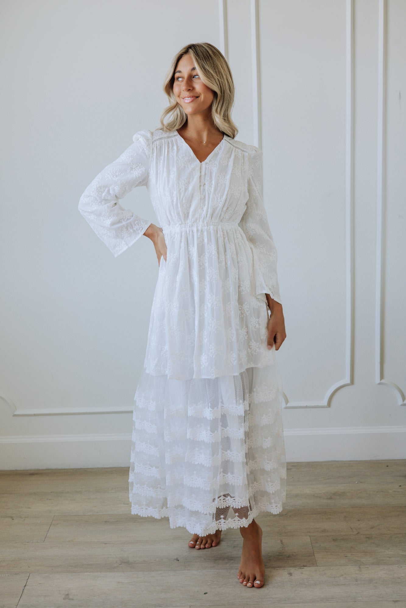 Women in a white long sleeve maxi dress
