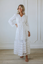 Women in a white long sleeve maxi dress