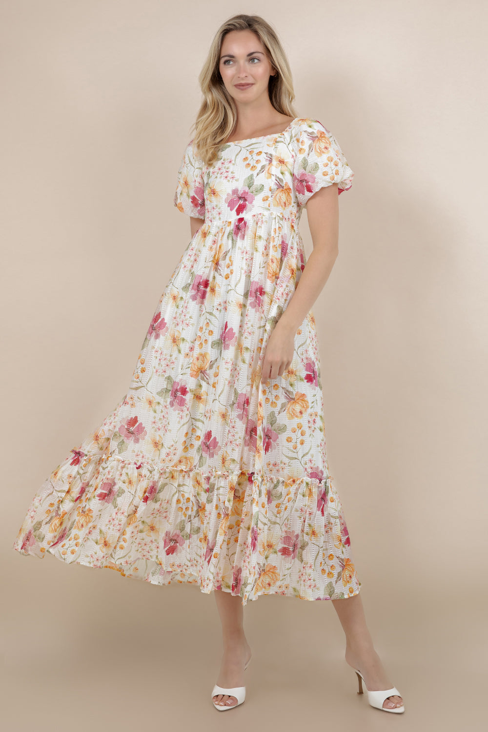Woman wearing a floral dress against a beige background