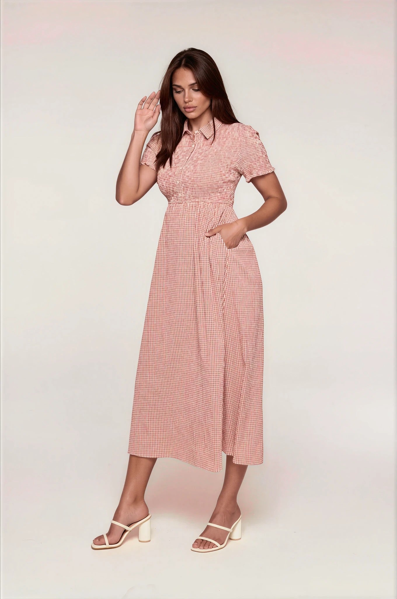 Woman wearing a red checkered dress on a white background