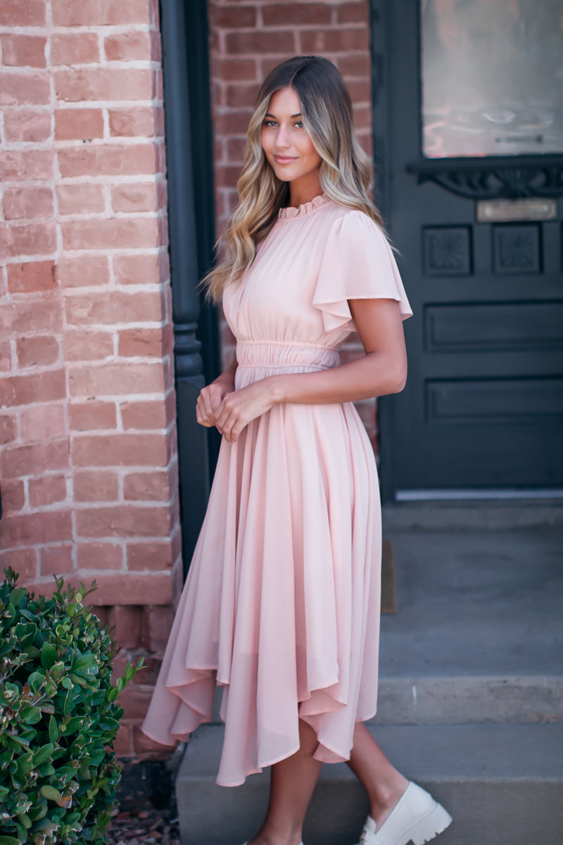 Pink dress with high neckline and flutter sleeves