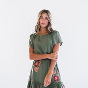 Mini green dress with short sleeves and floral details